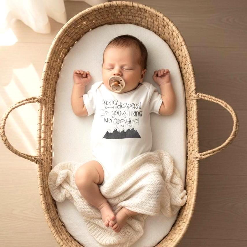 "Pack my diapers! I'm going hiking with Grandma!"  (Or daddy, mommy, auntie, uncle, grandpa.)  This hiking baby bodysuit or t-shirt is perfect for your newest hiking buddy!  This design makes a great baby shower gift for the outdoorsy family that loves hiking! The design is Grey and the mountains are a chalkboard style.  (design is not black)  Please select the phrase you need on the drop down menu.