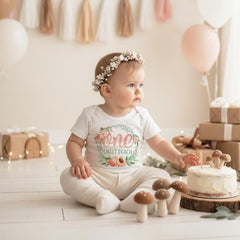 Peach First Birthday.  Such a pretty first birthday bodysuit or t-shirt for your little one!  It features a delicate watercolor floral wreath with peach accents and the words "one sweet peach".  Since all of Bella Lexi™ designs are printed directly onto the garments of your choice, the designs won't peel, crack or fade!  This peach birthday design also makes a wonderful gift!  Your little peach will look adorable for her special day!