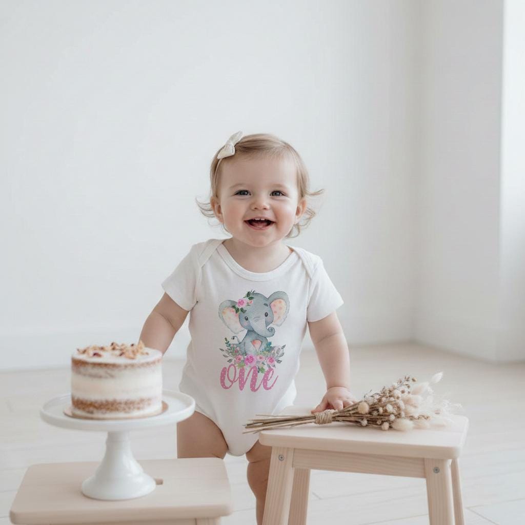 This is such an adorable Elephant themed Birthday onesie®, t-shirt or bodysuit!  Perfect for your little girl's first birthday party!  This custom design features a watercolor style elephant with floral elements in pinks and greens with the word "one" in polka dot pink.